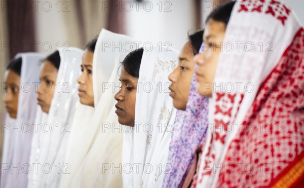Devotees pray in church during a Christmas day sermon on December 25, 2024 in Guwahati, India.