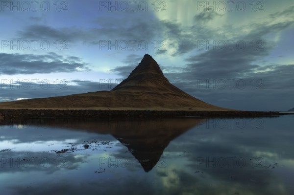 Northern Lights over Kirkjufell mountain, reflection in the sea, Grundarfjörður, Snæfellsnes