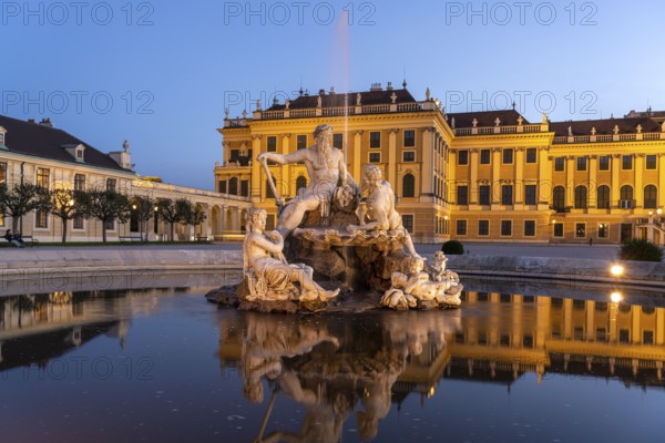 Fountain in the courtyard of honour at Schönbrunn Palace at dusk, UNESCO World Heritage Site in