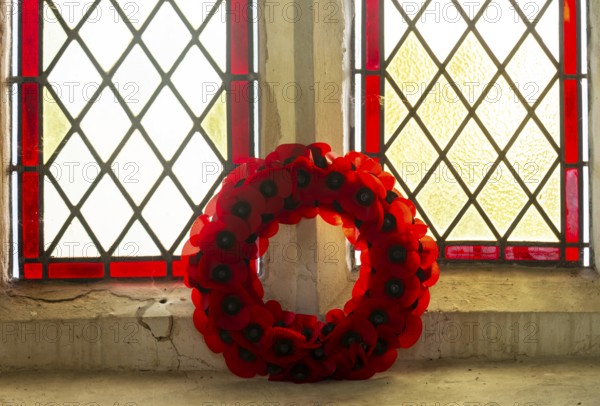 Poppy wreath in church window Remembrance events, Framsden church, Suffolk, England, UK