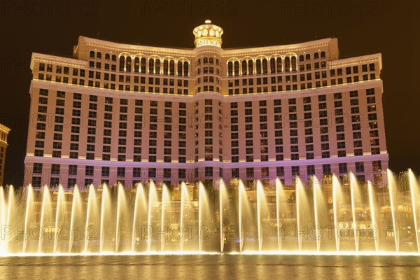 Illuminated Bellagio Hotel with water fountains in front of it at night, Las Vegas, Nevada, USA,