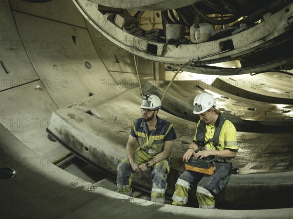 Workers in a tunnel section at the double-shield tunnel boring machine in section H53 of the