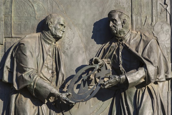 Pope John Paul II hands over the World Youth Day Cross to his successor Pope Benedict XVI, bronze