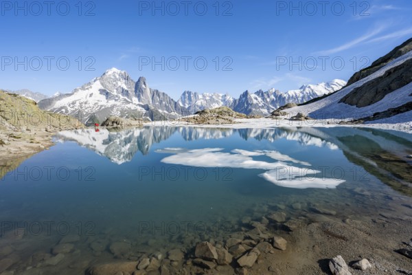 Mountain landscape with mountain lake and ice floe, water reflection in Lac Blanc, mountain peak,