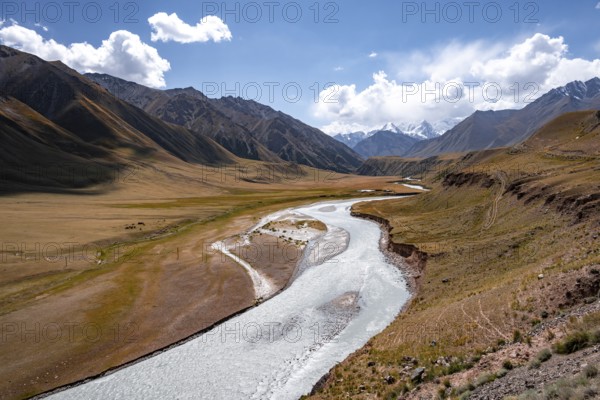 Mountain river in a valley, picturesque mountain landscape with white mountain peaks, Tian Shan