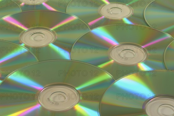 Several CD-ROMs with rainbow effect on the surface, close-up