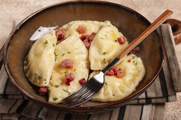 Dumplings, with fried prosciutto, a traditional dish of Polish cuisine, dumplings, top view,