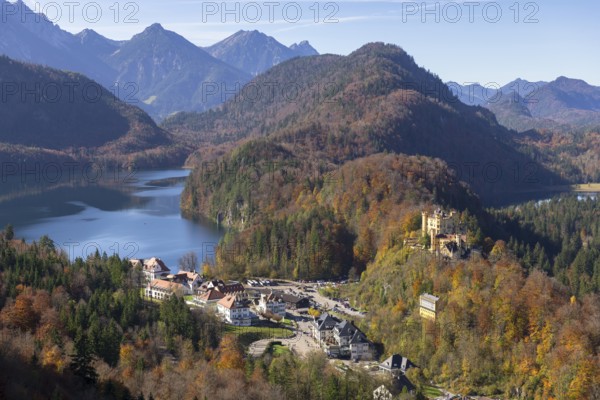 Idyllic valley with autumn-coloured forest, enchanting mountains and a tranquil lake, Schwansee,