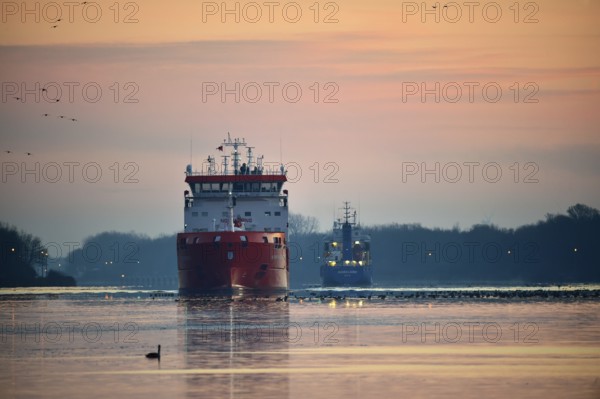 Ships, tanker, cargo ship meet at sunrise in the Kiel Canal, NOK, Kiel Canal, Schleswig-Holstein,
