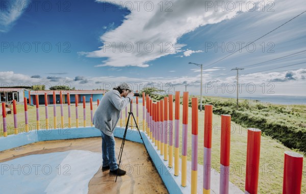 Person photographing landscape with a digital camera in a park. Photographer photographing a