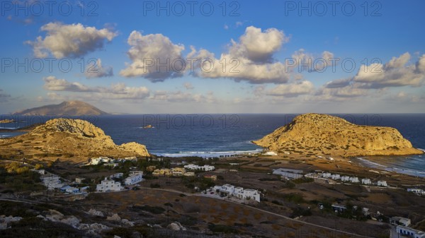 View of coastal village with white houses and rock formations in the background, Acropolis Hill,