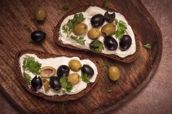 Breakfast, sandwiches, with cream cheese, olives, top view