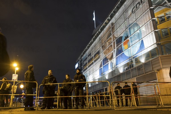 Police officers protect the CDU party headquarters during the demonstration under the slogan