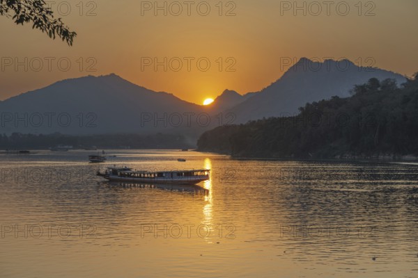 Sunset on the Mekong with excursion boats, near Luang Prabang, Laos, Asia