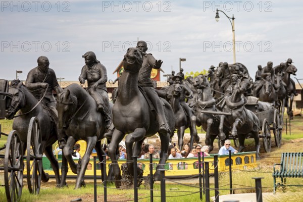Oklahoma City, Oklahoma - Tourists in a canal boat ride through a sculpture commemorating the