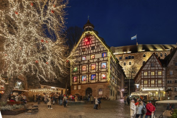 Historic Pilkatushaus with an Advent calendar on 18 December 2024 at dusk, behind the Imperial