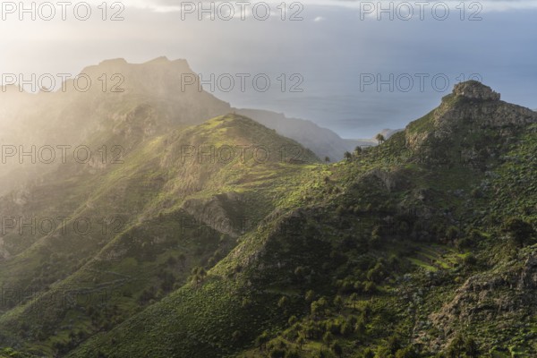 View of the Barranco Juan de Vera and its mountains, palm trees, rocks and sea. Near Mirador