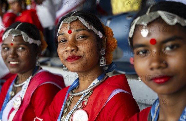 Girls from tea tribe community wearing traditional attire, wait to perform traditional Jhumur