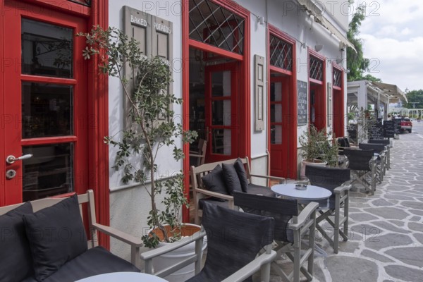 Inviting café with red façade and outdoor seating, Parikia, Paros, Cyclades, Greece, Europe