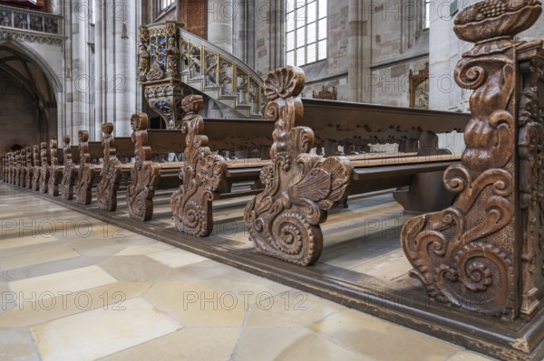 Cheeks of the pews in the late Gothic hall church of St George, Dinkelsbühl, Bavaria, Germany,
