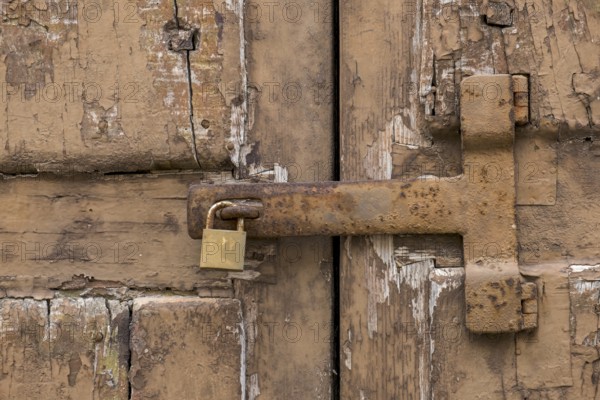 Dilapidated wooden gate with rusty metal fittings, Galatina, Apulia, Italy, Europe