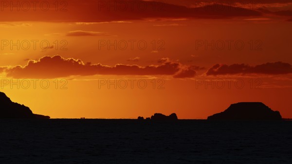 Tranquil island landscape at sunset, soft orange tones in the sky over the sea, sunset, Kassos,