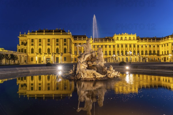 Fountain in the courtyard of honour at Schönbrunn Palace at dusk, UNESCO World Heritage Site in