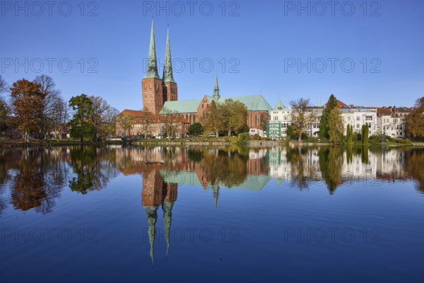 Mill pond with general buildings, Lübeck Cathedral and trees, symmetrical reflections on the water