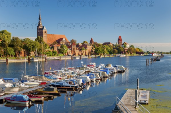 View over the Elbe harbour with boats to the old town with St. Stephen's church, town wall, castle