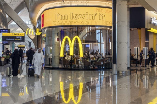 Abu Dhabi Airport, Zayed International Airport with passengers. McDonalds restaurant. The new