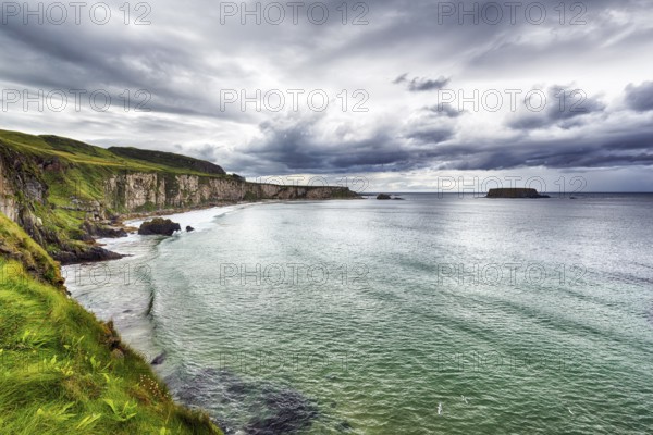 View of the sea, cliff coast, chalk cliffs, dramatic cloudy sky, rain clouds, Causeway Coastal