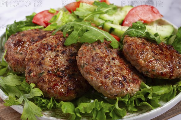 Fried cutlets, mixed minced meat, with vegetable salad, homemade, top view, no people