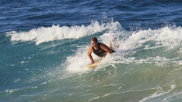 Surfer fights against the powerful waves in the blue ocean, wave surfer, surfer, surf, waves, west