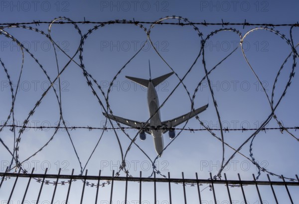 Symbolic image security at the airport, outer fence at Düsseldorf International Airport, steel wire