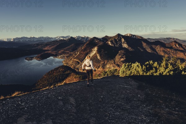 Trail running in autumn on the Jochberg on Lake Walchensee against the wonderful backdrop of the