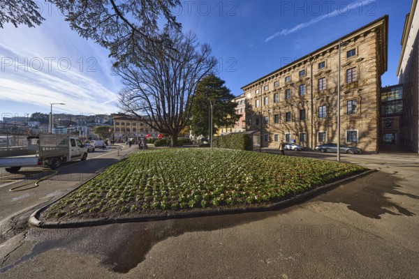Piazza Manzoni, historical buildings, flower bed, trees, blue sky, veil clouds, street Riva