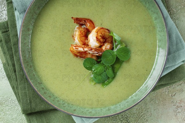 Pea cream soup, with shrimp, green soup, homemade, top view, no people