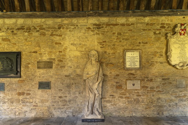 Statue of St John the Baptist in the cloisters of New College, University of Oxford, Oxfordshire,