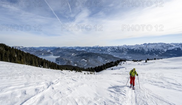 Ski tourers climbing Simetsberg, view of Walchensee, Estergebirge, Bavarian Prealps, Bavaria