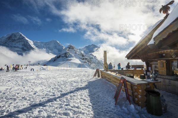 Wooden chalet and ski slope, with views of the Eiger, Mönch and Tschuggen, Grindelwald, Bernese