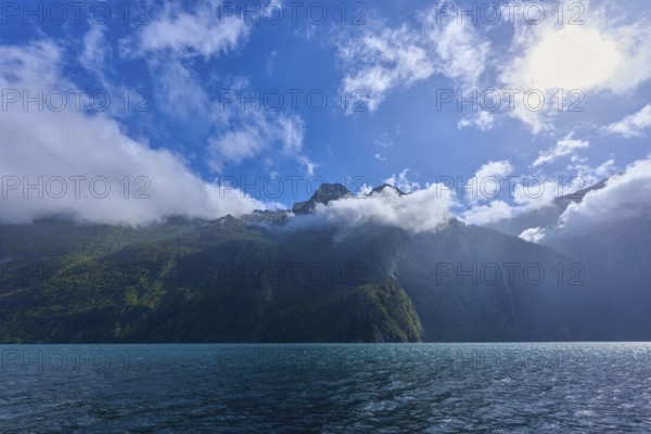 Cloudy sky over a quiet, green mountain landscape, summer, Milford Sound, Te Anau, Fiordland