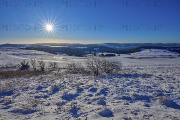 Snow-covered hills under a bright sun and clear sky, winter, Wasserkuppe, Gersfeld, Rhön, Hesse,