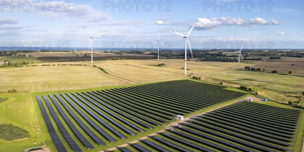 Wind farm and solar cells renewable energy wind power wind energy on the Baltic Sea aerial view