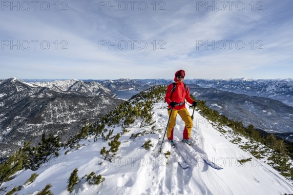 Ski tourer at the summit of Simetsberg, mountain panorama, Estergebirge, Bavarian Prealps, Bavaria