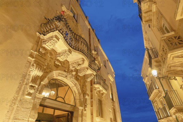 Historic district traditional buildings illuminated at dusk, Ortygia, Syracuse, Sicily, Italy,