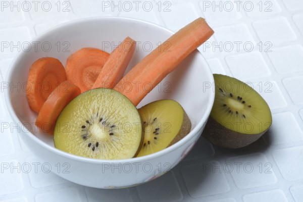 Sliced carrot and kiwi slices in peel, kiwi fruit and carrot