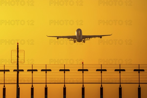 Aircraft taking off from the main runway south, 05R/23L, runway lighting, approach aids, at