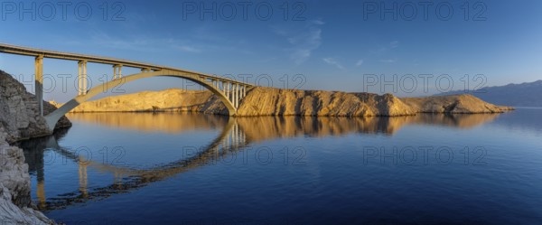 Pag bridge over calm water in soft morning light with clear reflections, Pag, Zadar, Croatia,