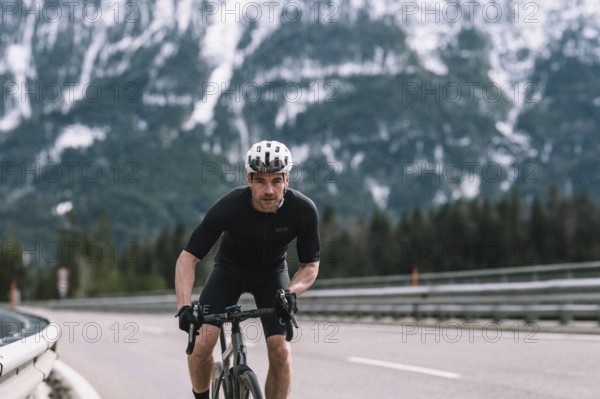 Road bike rider in spring between Lechtal and Tannheimer Tal in front of picturesque scenery of the