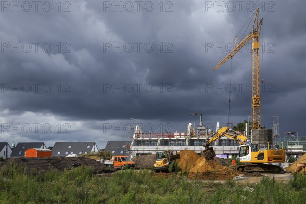 Bottrop, North Rhine-Westphalia, Germany, Housing construction in new development area. Dark clouds